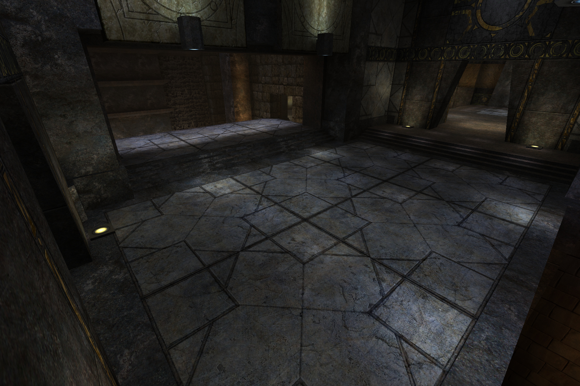 A dim stone hall with a patterned tiled floor, carved wall bands and a few small yellow floor lights.